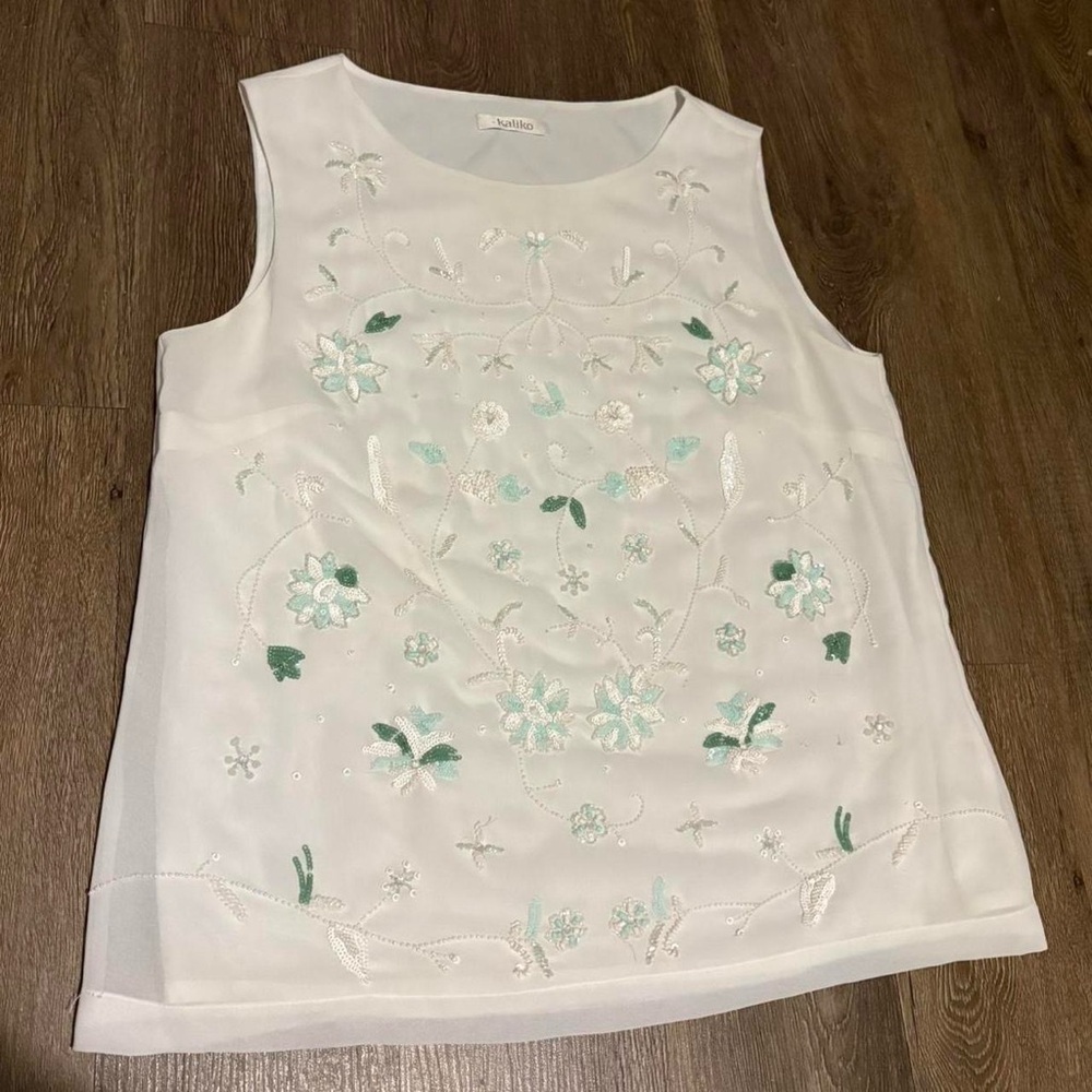 White tank top with a beaded floral design